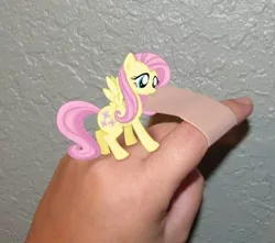 Size: 498x440 | Tagged: safe, derpibooru import, fluttershy, human, pony, bandaid, cute, finger, hand, irl, micro, photo, ponies in real life, real life background