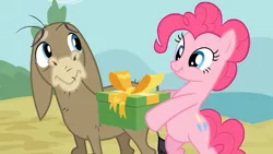 Size: 500x281 | Tagged: safe, derpibooru import, screencap, cranky doodle donkey, pinkie pie, donkey, earth pony, pony, a friend in deed, astartes pattern baldness, bipedal, duo, hoof hold, present, scrunchy face