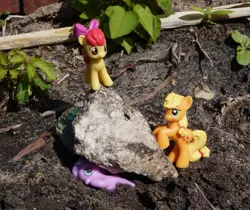 Size: 891x750 | Tagged: abuse, apple bloom, applejack, blind bag, boulder, crushing, derpibooru import, diamond tiara, imminent death, irl, murder, outdoors, photo, rock, safe, tiarabuse, toy, witch trials