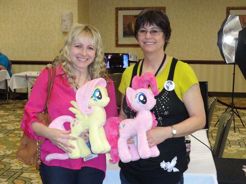 Size: 2592x1944 | Tagged: andrea libman, artist:whitedove-creations, bag, button, convention, derpibooru import, fluttershy, glasses, happy, human, irl, irl human, nerdkon, photo, pinkie pie, plushie, rarity, safe, smiling, voice actor