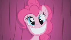 Size: 1280x720 | Tagged: safe, derpibooru import, screencap, pinkie pie, earth pony, pony, derp, grin, image, jpeg, smiling, solo, wall eyed