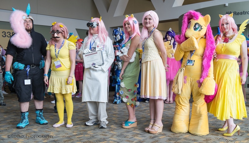 Size: 1280x732 | Tagged: artist needed, artist:xenro8, bronycon, bunny ears, cosplay, dangerous mission outfit, derpibooru import, element of kindness, fluttershy, fursuit, groucho mask, group photo, human, irl, irl human, optimus prime, photo, rule 63, safe