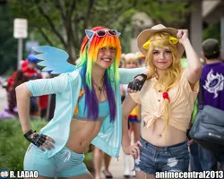 Size: 2047x1638 | Tagged: anime central, anime central 2013, applejack, artist needed, belly button, bellyring, clothes, cosplay, derpibooru import, fingerless gloves, front knot midriff, gloves, human, irl, irl human, midriff, photo, rainbow dash, safe, shorts, sunglasses