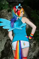 Size: 570x855 | Tagged: safe, artist:nikkinevermore, derpibooru import, rainbow dash, human, back, clothes, cosplay, fingerless gloves, gloves, irl, irl human, merchandise, photo, solo, tail