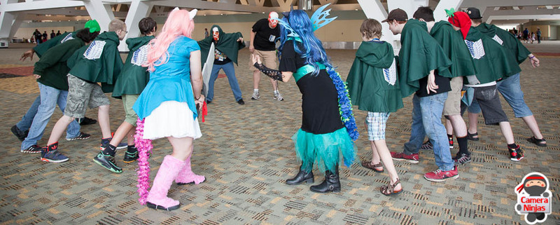 Size: 1024x411 | Tagged: artist needed, safe, artist:jimthecactus, derpibooru import, pinkie pie, queen chrysalis, human, bronycon, 2014, anime, attack on titan, convention, cosplay, crossover, fight, irl, irl human, photo, solo