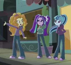 Size: 787x720 | Tagged: safe, derpibooru import, screencap, adagio dazzle, aria blaze, sonata dusk, equestria girls, rainbow rocks, clothes, diner, gem, hoodie, jewelry, necklace, outdoors, sidewalk, siren gem, the dazzlings, wind