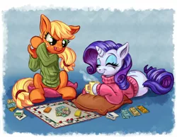 Size: 2000x1549 | Tagged: safe, artist:harwick, derpibooru import, applejack, rarity, earth pony, pony, unicorn, board game, clothes, coffee mug, dice, eyes closed, female, lesbian, mare, monopoly, mug, pillow, prone, rarijack, rarijack daily, shipping, shirt, smiling, sweater, this will end in tears, tongue out