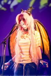 Size: 683x1024 | Tagged: 2014, artist needed, collar, cosplay, derpibooru import, flutterbat, fluttershy, human, irl, irl human, microphone, photo, rubronycon, safe, solo, stage