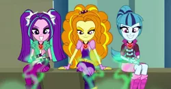 Size: 1919x1000 | Tagged: safe, derpibooru import, screencap, adagio dazzle, aria blaze, sonata dusk, equestria girls, rainbow rocks, crossed legs, empowerment, evil grin, female, gem, grin, lidded eyes, looking down, negative energy, siren gem, smiling, the dazzlings, trio