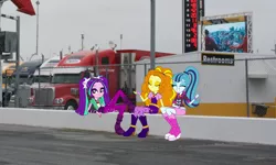 Size: 1276x764 | Tagged: safe, derpibooru import, adagio dazzle, aria blaze, sonata dusk, equestria girls, cute, daytona usa, equestria girls in real life, eyes closed, hauler, looking at you, nascar, photo, race track, racing, sign, sitting, sultry pose, the dazzlings, truck