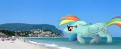 Size: 1200x490 | Tagged: safe, artist:fandroit, derpibooru import, rainbow dash, pony, beach, giant pony, giant rainbow dash, irl, macro, mega/giant rainbow dash, photo, ponies in real life