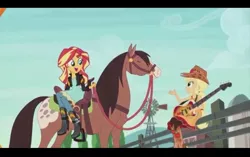 Size: 1024x645 | Tagged: safe, derpibooru import, screencap, applejack, sunset shimmer, horse, equestria girls, friendship through the ages, country applejack, farm, guitar, humans riding horses, open mouth, riding, sidesaddle, sitting, sleeveless, smiling