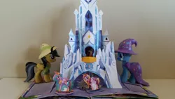 Size: 1594x896 | Tagged: safe, derpibooru import, daring do, princess cadance, princess celestia, shining armor, trixie, pony, unicorn, book, castles of equestria, crystal castle, female, mare, pop-up book