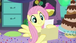 Size: 1280x720 | Tagged: cake, cute, derpibooru import, file, fluttershy, folder, food, grin, hoof hold, paper, party pooped, reading, safe, screencap, solo, spread wings