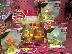 Size: 650x488 | Tagged: safe, derpibooru import, photographer:drpain, apple fritter, apple munchies, applejack, jonagold, marmalade jalapeno popette, earth pony, pony, apple family member, applejack's hat, background pony, blind bag, bucking, cider stand, cowboy hat, female, hat, irl, mare, photo, raised hoof, rearing, saddle, tack, toy