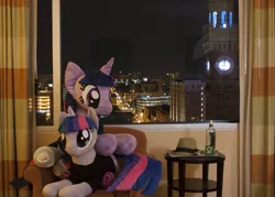 Size: 1507x1080 | Tagged: safe, artist:mylittlewaifu, artist:plushwaifus, derpibooru import, twilight sparkle, unicorn, bronycon, bronycon 2015, baltimore, bottle, city, clothes, curtains, fedora, hat, horn, indoors, irl, life size, night, photo, plushie, socks, striped socks, tail, window