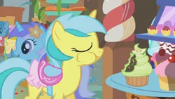 Size: 1280x720 | Tagged: safe, derpibooru import, screencap, diamond mint, lemony gem, lightning bolt, white lightning, pegasus, pony, unicorn, call of the cutie, background pony, clothes, cupcake, eyes closed, female, flower, flower in hair, food, mare, puffy cheeks, saddle, skirt, tack