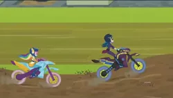 Size: 1440x810 | Tagged: safe, derpibooru import, screencap, indigo zap, rainbow dash, equestria girls, friendship games, motorcross, motorcycle, race, riding