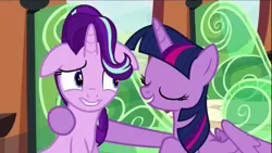 Size: 1280x720 | Tagged: safe, derpibooru import, screencap, starlight glimmer, twilight sparkle, twilight sparkle (alicorn), alicorn, pony, the crystalling, castle, female, floppy ears, hug, mare, nervous grin, new hairstyle, raised eyebrow