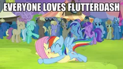 Size: 711x400 | Tagged: safe, derpibooru import, screencap, fluttershy, rainbow dash, trade ya, cheering, crowd, female, flutterdash, glomp, hug, image macro, lesbian, lying down, lying on top of someone, meme, on back, shipping