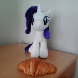 Size: 920x920 | Tagged: 4de, bread, croissant, derpibooru import, desk, food, irl, photo, plushie, rarity, rarity looking at food, safe, solo