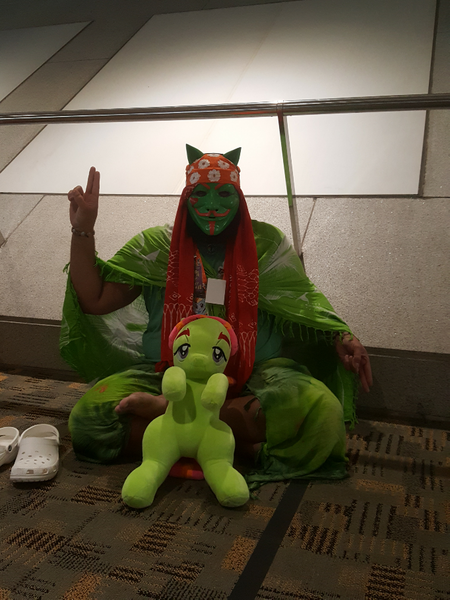 Size: 682x909 | Tagged: anonymous, artist needed, bandana, bronycon, bronycon 2016, clothes, cosplay, costume, derpibooru import, guy fawkes mask, human, irl, irl human, photo, plushie, pose, safe, sarong, sitting, solo, tree hugger