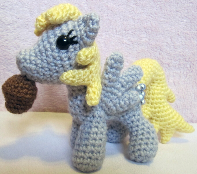 Size: 1024x901 | Tagged: safe, artist:nerdyknitterdesigns, derpibooru import, derpy hooves, pegasus, pony, amigurumi, female, food, irl, mare, muffin, photo, plushie, solo