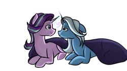Size: 1280x720 | Tagged: safe, artist:doodledonut, derpibooru import, starlight glimmer, trixie, pony, unicorn, blanket, female, floppy ears, heart, lesbian, looking at each other, magic, mare, prone, shipping, simple background, smiling, startrix, transparent background