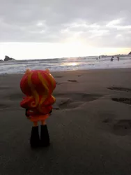 Size: 1944x2592 | Tagged: safe, derpibooru import, sunset shimmer, human, equestria girls, beach, clothes, doll, equestria girls minis, eqventures of the minis, irl, irl human, ocean, photo, pun, sand, skirt, sunset, toy, visual pun