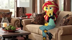 Size: 533x294 | Tagged: safe, derpibooru import, sunset shimmer, equestria girls, boots, candle, clothes, couch, crossed legs, equestria girls in real life, high heel boots, house, indoors, interview, irl, pants, photo, sitting, solo