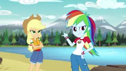 Size: 1280x720 | Tagged: safe, derpibooru import, screencap, applejack, rainbow dash, equestria girls, legend of everfree, clothes, cowboy hat, crossed arms, denim, freckles, hat, lake, lifejacket, mountain, mountain range, pants, pointing, scenery, shorts, smirk, stetson, tree