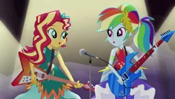 Size: 1280x720 | Tagged: safe, derpibooru import, screencap, rainbow dash, sunset shimmer, equestria girls, legend of everfree, clothes, crystal gala, dress, electric guitar, flying v, guitar, guitar pick, legend you were meant to be, microphone, spotlight, stage, sunset shredder