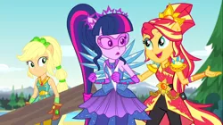 Size: 1100x618 | Tagged: safe, derpibooru import, screencap, applejack, sci-twi, sunset shimmer, twilight sparkle, equestria girls, legend of everfree, clothes, crystal guardian, crystal wings, gloves, open mouth, pants, ponied up, scenery, super ponied up, super strength