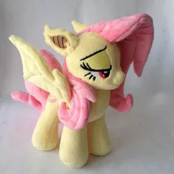 Size: 960x960 | Tagged: safe, artist:burgunzik, derpibooru import, fluttershy, bat pony, pony, flutterbat, irl, lidded eyes, photo, plushie, race swap, solo, spread wings