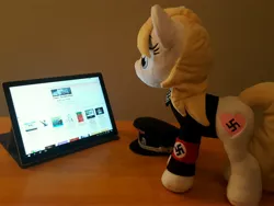 Size: 3984x2988 | Tagged: safe, artist:anonymous, derpibooru import, oc, oc:aryanne, unofficial characters only, earth pony, pony, /mlpol/, clothes, female, irl, mare, nazi, photo, plushie, solo, surface, surface pro, swastika, tablet, uniform