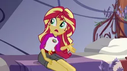 Size: 1280x720 | Tagged: safe, derpibooru import, screencap, sunset shimmer, equestria girls, legend of everfree, bed, camp everfree outfits, clothes, female, legs, open mouth, shorts, sitting, solo