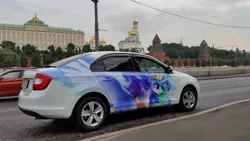 Size: 1024x576 | Tagged: artist:cannibalus, car, decal, derpibooru import, frown, glare, irl, itasha, kremlin, moscow, photo, pretty, princess celestia, russia, safe, skoda, skoda rapid, spread wings