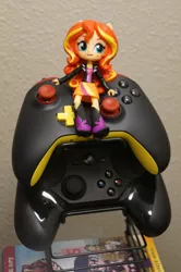 Size: 3264x4912 | Tagged: safe, derpibooru import, sunset shimmer, equestria girls, friendship games, clothes, doll, dvd, equestria girls minis, irl, photo, skirt, steam controller, toy, xbox one controller