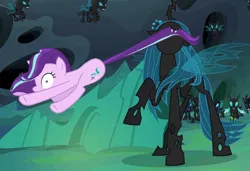 Size: 479x328 | Tagged: safe, derpibooru import, screencap, queen chrysalis, starlight glimmer, thorax, changeling, changeling queen, pony, unicorn, to where and back again, changeling guard, female, mare, nom, nose in the air, raised hoof, shrunken pupils, smiling, tail, tail bite, tail pull, this will end in pain, throwing, wide eyes