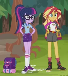 Size: 474x533 | Tagged: safe, derpibooru import, screencap, sci-twi, sunset shimmer, twilight sparkle, equestria girls, legend of everfree, backpack, boots, camp everfree outfits, clothes, converse, hand on hip, shoes, shorts, sneakers, tree