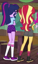 Size: 363x614 | Tagged: safe, derpibooru import, screencap, sci-twi, sunset shimmer, twilight sparkle, equestria girls, legend of everfree, camp everfree outfits, clothes, converse, cropped, crossed arms, hand on hip, raised leg, rear view, shoes, sneakers