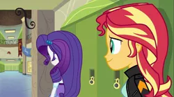 Size: 1100x618 | Tagged: safe, derpibooru import, screencap, rarity, sunset shimmer, equestria girls, friendship games, clothes, hallway, jacket, leather jacket, lockers, rear view, skirt