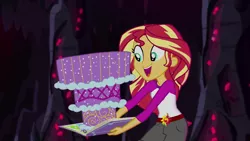 Size: 1280x720 | Tagged: safe, derpibooru import, screencap, sunset shimmer, equestria girls, legend of everfree, book, cake, camp everfree outfits, clothes, crystal gala, food, legend you were meant to be, open mouth, shorts, solo