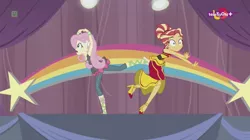 Size: 1136x638 | Tagged: safe, derpibooru import, screencap, fluttershy, sunset shimmer, dance magic, equestria girls, spoiler:eqg specials, accident, alternate hairstyle, awkward moment, canterlot high, clothes, dancing, dress, duo, female, high heels, rainbow, shoes, skirt, stars, teletoon, tutu