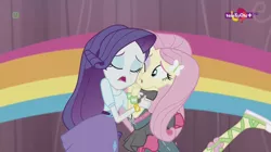 Size: 1136x638 | Tagged: safe, derpibooru import, screencap, fluttershy, rarity, dance magic, equestria girls, spoiler:eqg specials, ballet slippers, canterlot high, clothes, duo, eyes closed, female, one eye open, open mouth, rainbow, skirt, teletoon