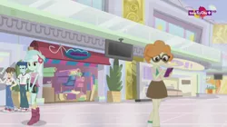 Size: 1136x638 | Tagged: safe, derpibooru import, screencap, curly winds, lyra heartstrings, scribble dee, some blue guy, wiz kid, dance magic, equestria girls, spoiler:eqg specials, background human, book, boots, canterlot mall, clothes, converse, female, glasses, haberdashery, male, mall, shoes, shorts, skirt, sneakers, socks, teletoon, television