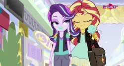 Size: 1364x724 | Tagged: safe, derpibooru import, screencap, starlight glimmer, sunset shimmer, equestria girls, mirror magic, spoiler:eqg specials, bag, beanie, clothes, eating, face, food, geode of empathy, hat, hug, ice cream, ice cream cone, lidded eyes, magical geodes, messy eating, teletoon, thick, wat, wide hips