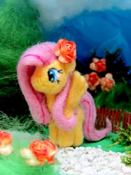 Size: 1500x2007 | Tagged: safe, artist:atelok, derpibooru import, fluttershy, pony, felt, flower, flower in hair, irl, looking away, needle felted, no mouth, photo, plushie, solo, spread wings, standing, wings