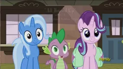 Size: 1392x780 | Tagged: safe, derpibooru import, screencap, spike, starlight glimmer, trixie, dragon, pony, unicorn, all bottled up, animation error, baby, baby dragon, cute, diatrixes, discovery family, discovery family logo, female, glimmerbetes, hair flip, logo, male, mare, saddle bag, smiling, spikabetes, the amazing trio of friendship, thousand yard stare, train station, watermark