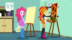 Size: 1278x718 | Tagged: safe, derpibooru import, screencap, pinkie pie, sunset shimmer, eqg summertime shorts, equestria girls, the art of friendship, apron, boots, brush, clothes, easel, paint, painting, shoes